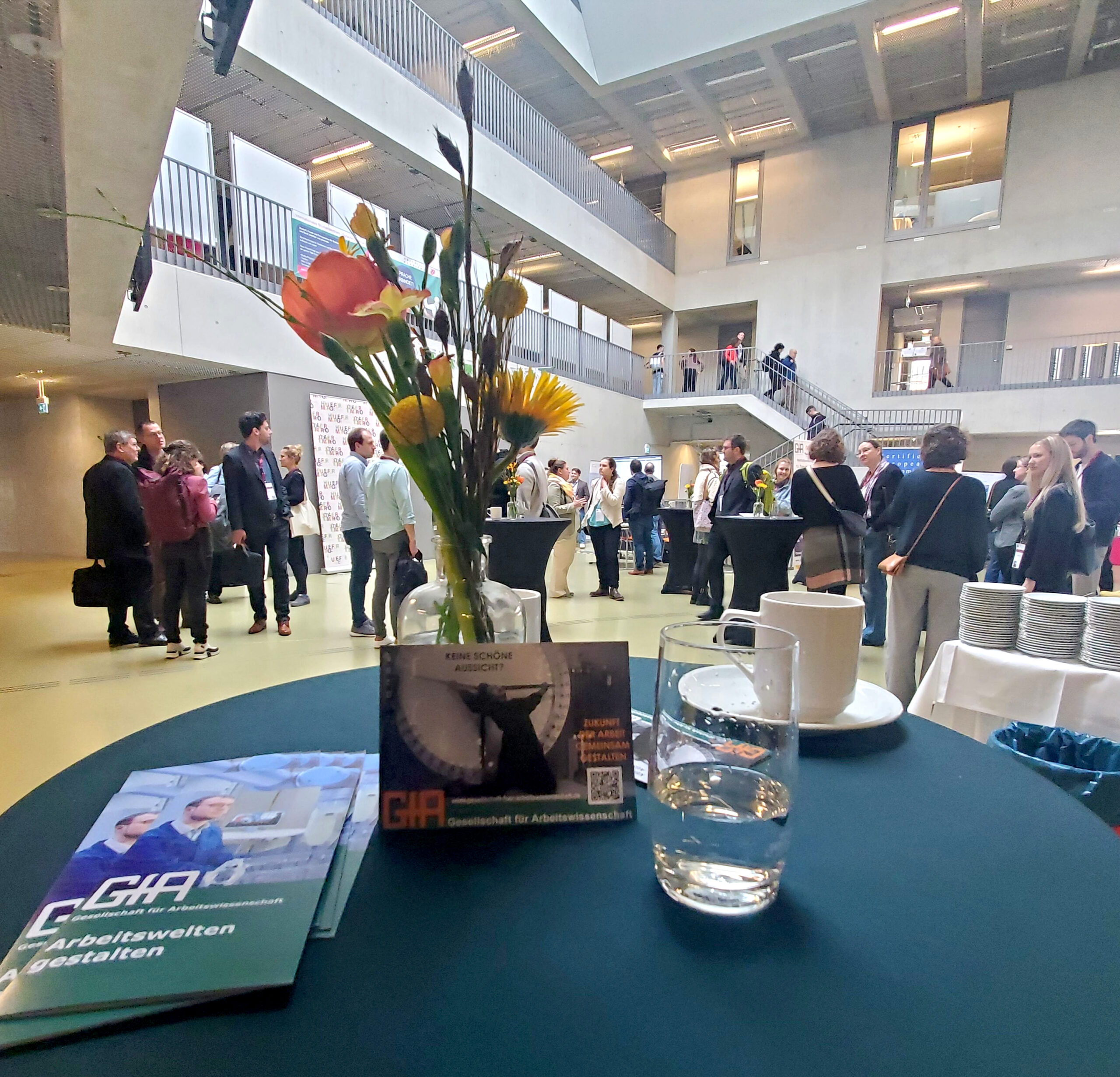 Besucher:innen der GfA Konferenz nnetzwerken in der Halle.